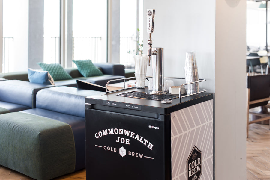 Commonwealth Joe cold brew keg tap station set up in a stylish office lounge — delivering convenience and craft quality through premium office coffee service.