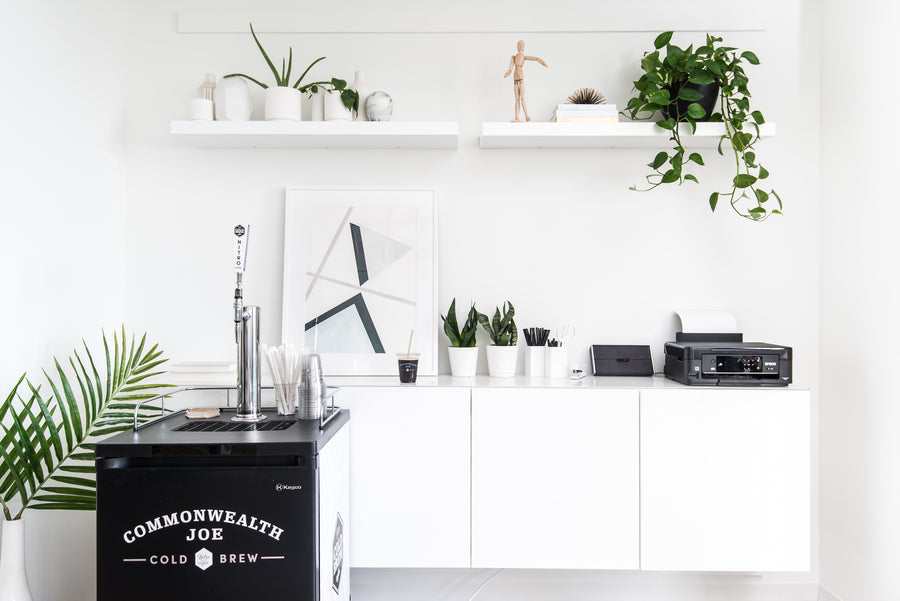 Sleek modern office breakroom featuring a Commonwealth Joe cold brew tap setup — a stylish and functional perk of premium office coffee service.